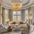 Modern luxury chandelier featuring layered, golden monstera leaves.